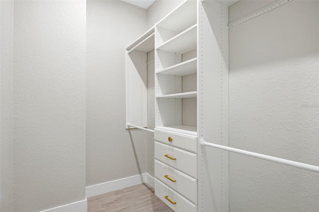 spacious closet with light hardwood / wood-style floors