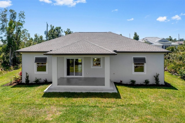 rear view of house with a patio area and a lawn