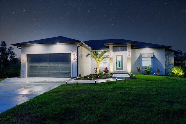 view of front of house featuring a garage and a yard