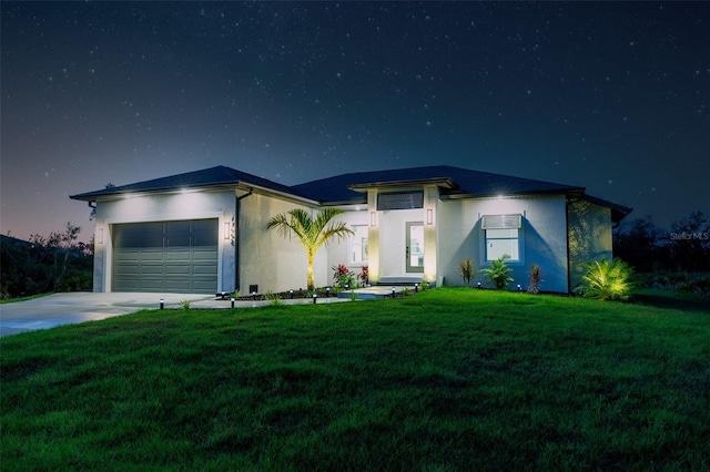 view of front of home with a garage and a front yard