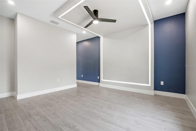 spare room with light wood-type flooring and ceiling fan