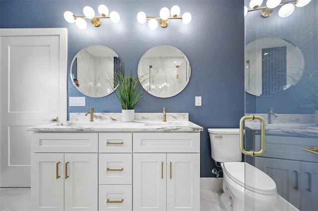 bathroom featuring a shower with shower door, toilet, and vanity