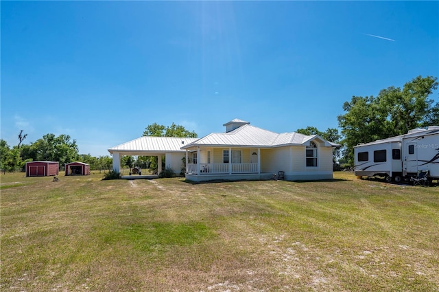 rear view of property with a lawn