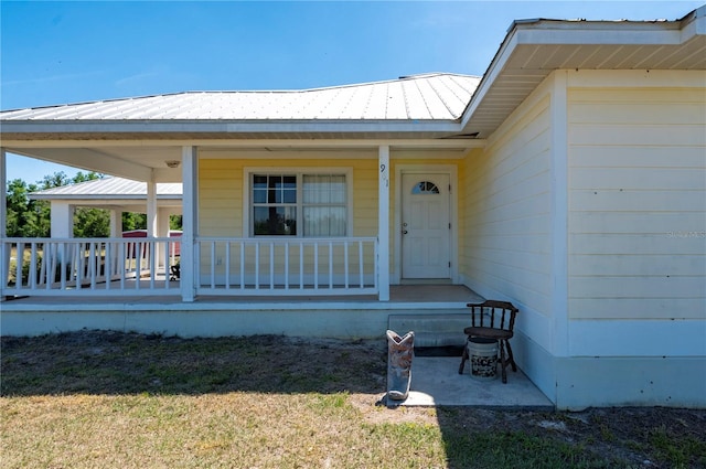 view of exterior entry with a lawn