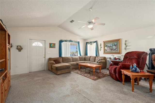 living room featuring light carpet, ceiling fan, a textured ceiling, and lofted ceiling