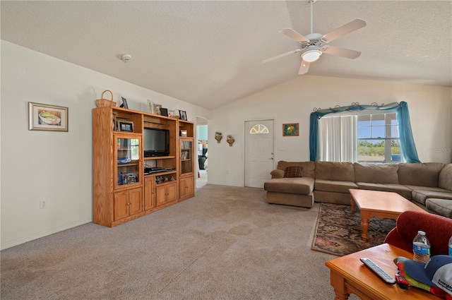 carpeted living room featuring ceiling fan and lofted ceiling