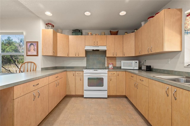 kitchen with sink, white appliances, and light brown cabinets