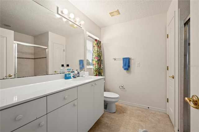 bathroom featuring toilet, tile flooring, vanity, and a textured ceiling