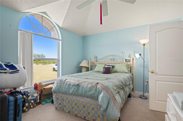 bedroom featuring light colored carpet, a textured ceiling, and ceiling fan