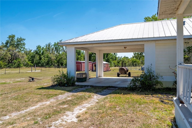 view of yard featuring a patio and a storage unit