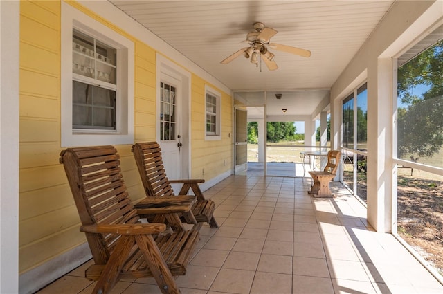 sunroom / solarium with ceiling fan and a healthy amount of sunlight