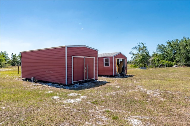 view of shed / structure with a lawn