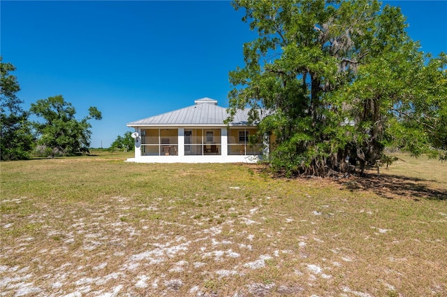 rear view of house featuring a yard