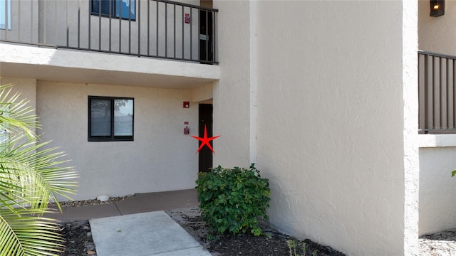 entrance to property featuring a balcony