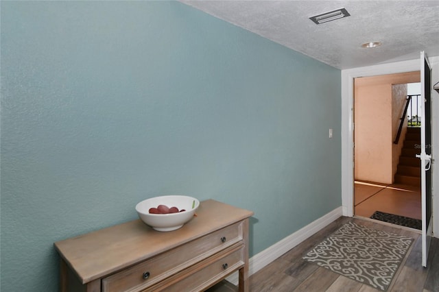 interior space with dark hardwood / wood-style flooring and a textured ceiling