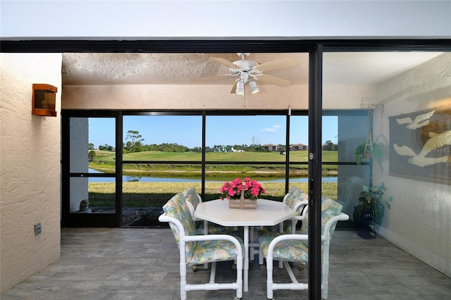 sunroom with a wealth of natural light and ceiling fan