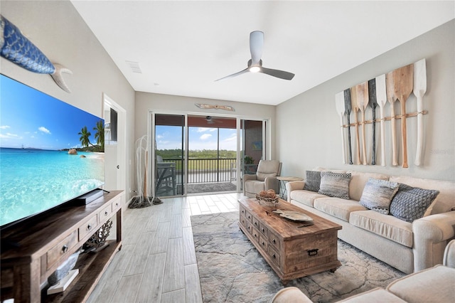 living room with light hardwood / wood-style floors and ceiling fan