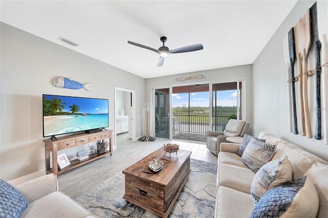 living room with wood-type flooring and ceiling fan