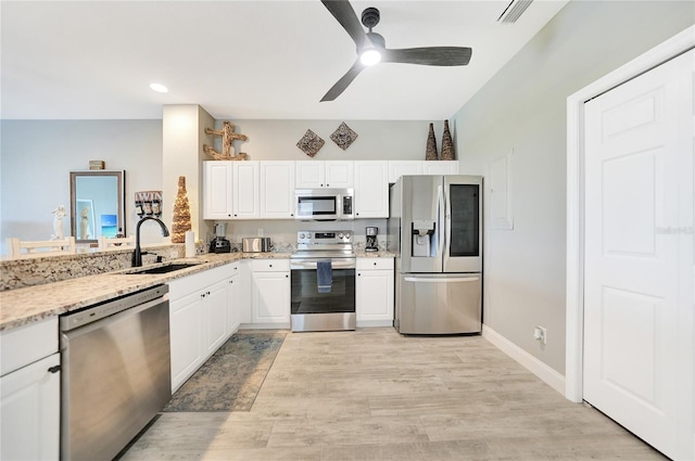 kitchen with light hardwood / wood-style flooring, ceiling fan, stainless steel appliances, white cabinetry, and sink