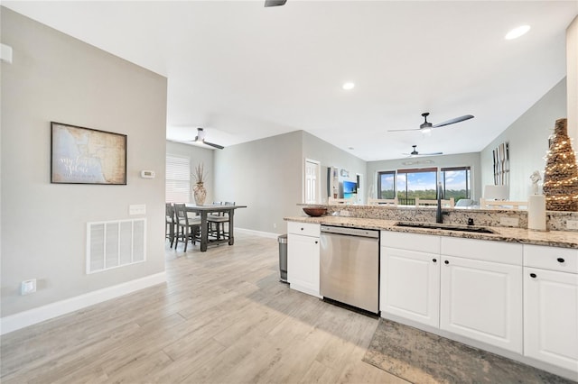 kitchen featuring light stone counters, dishwasher, ceiling fan, and white cabinetry