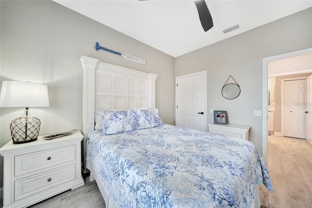 bedroom with light hardwood / wood-style floors and ceiling fan