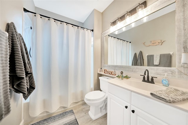 full bathroom with vanity with extensive cabinet space, shower / bathtub combination with curtain, toilet, and hardwood / wood-style flooring