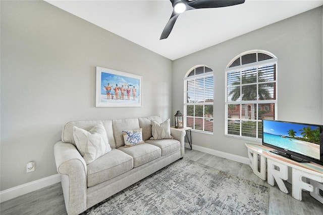 living room featuring hardwood / wood-style floors and ceiling fan