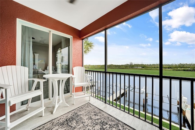 sunroom / solarium with plenty of natural light and a water view