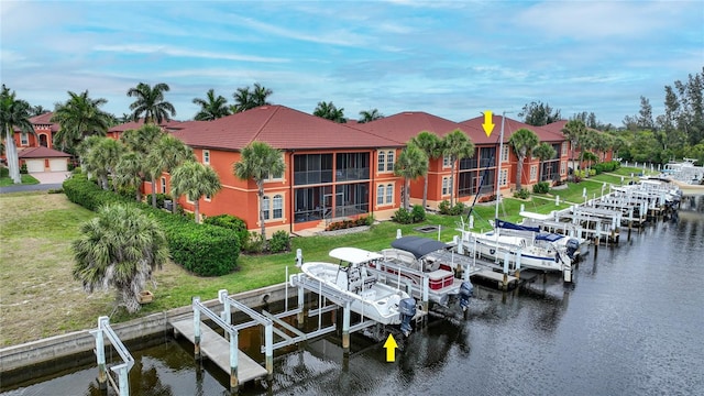 view of dock featuring a lawn and a water view