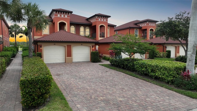 mediterranean / spanish house featuring a garage