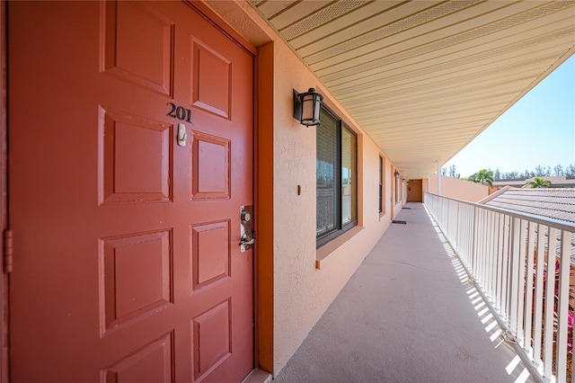 view of exterior entry featuring a balcony