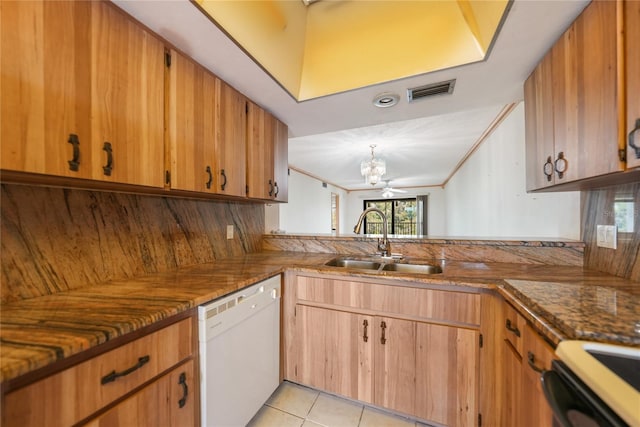 kitchen featuring hanging light fixtures, white dishwasher, light tile floors, sink, and ceiling fan