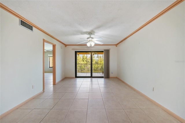 spare room with ornamental molding, ceiling fan, light tile floors, and a textured ceiling