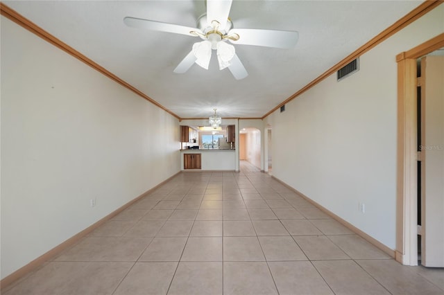 tiled spare room featuring ceiling fan and crown molding