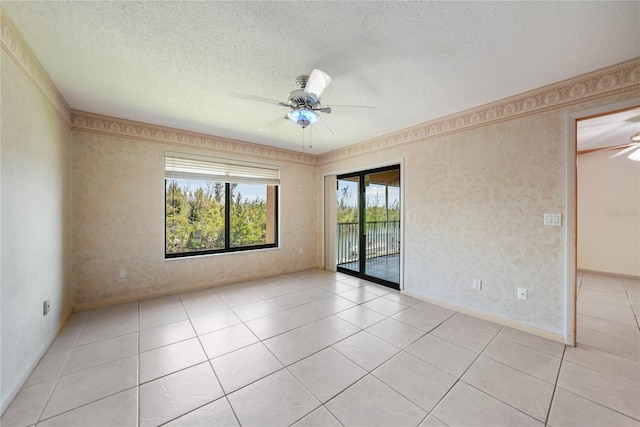 tiled spare room featuring ceiling fan and a textured ceiling