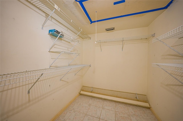 walk in closet featuring tile flooring