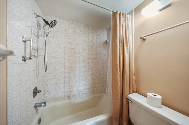 bathroom with shower / tub combo and toilet