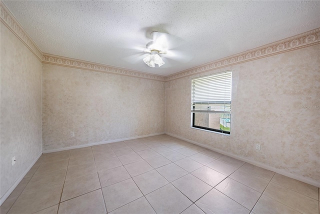 empty room with a textured ceiling, ceiling fan, and light tile floors