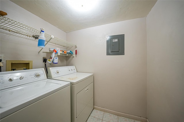 washroom with washer hookup, light tile floors, and washer and clothes dryer