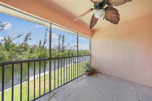 exterior space with ceiling fan and a water view