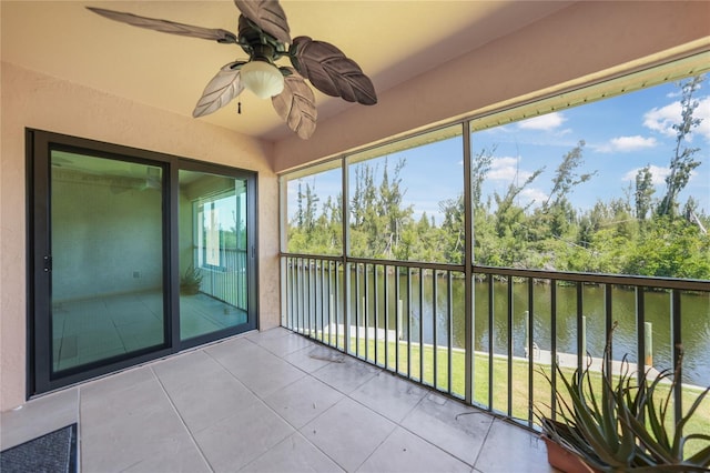 unfurnished sunroom featuring ceiling fan