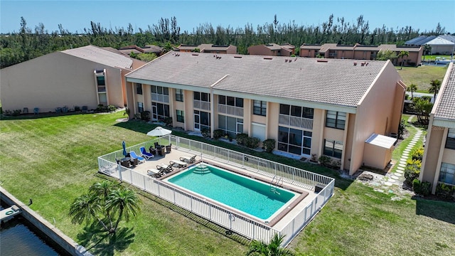 view of pool featuring a patio and a lawn