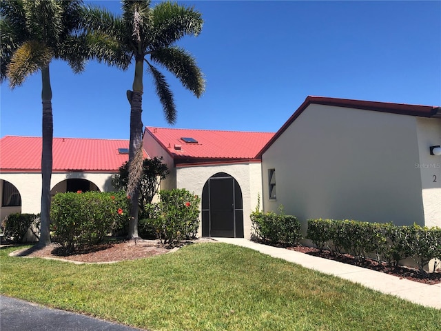 mediterranean / spanish-style house with a front lawn