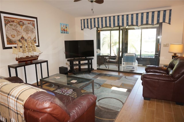 living room with dark hardwood / wood-style floors and ceiling fan