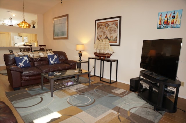 living room featuring vaulted ceiling and hardwood / wood-style flooring