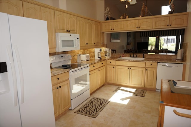 kitchen featuring white appliances, light brown cabinets, light tile floors, sink, and tasteful backsplash