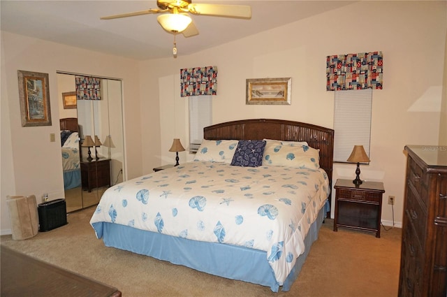 carpeted bedroom featuring a closet and ceiling fan