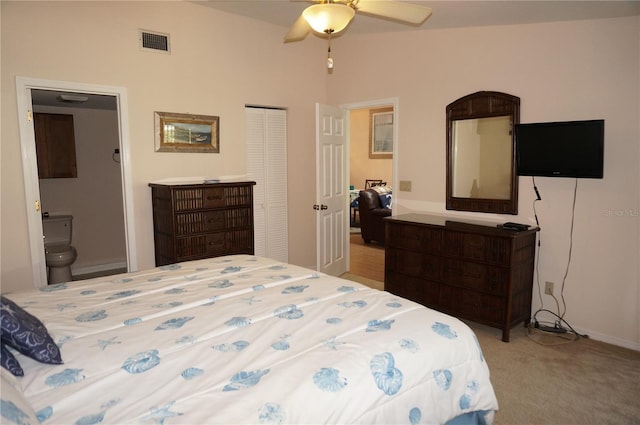 bedroom featuring ensuite bath, ceiling fan, lofted ceiling, light carpet, and a closet