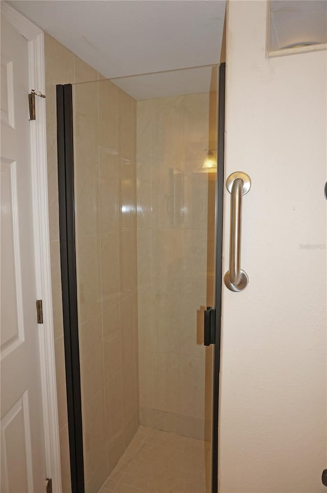 bathroom featuring a shower with door