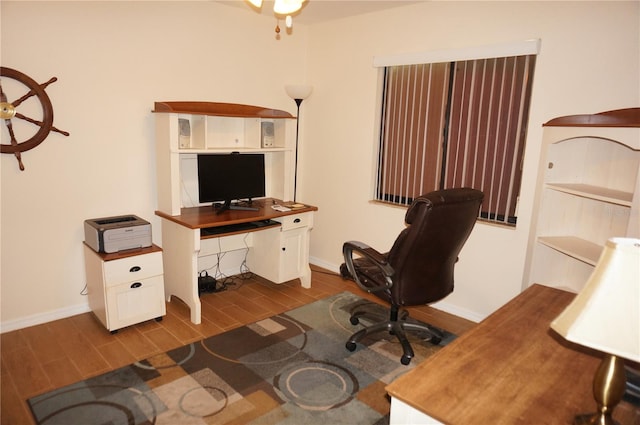 home office with dark hardwood / wood-style flooring